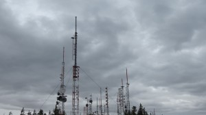 There is a large radio site with powerful transmitters near the summit.